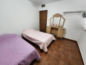 a bedroom with a bed and a dresser with a mirror at Casa ROMA in Ciudad Obregón