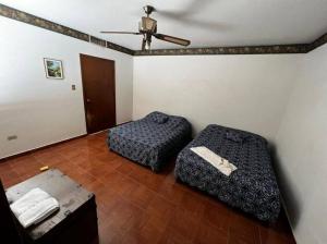 a room with two beds and a ceiling at Casa ROMA in Ciudad Obregón