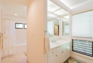 a bathroom with a sink and a mirror at 2511 Ridge in Kahana +32 photos