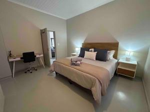 a bedroom with a bed with a stuffed animal on it at Comfortable home centrally located in Hoedspruit in Hoedspruit
