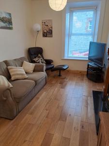 a living room with a couch and a television at Drogheda Townhouse in Drogheda