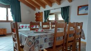 a dining room with a table and chairs at Baita al Pian in Bormio