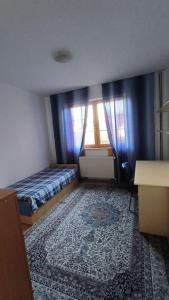 a small room with a bed and a window at Cozy Ivana's Apartment in Skopje