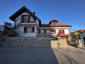 a large white house with a stone wall at Home Sweet Home Apartment in Agerola
