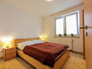 Postel nebo postele na pokoji v ubytování Ferienhaus Zur Döpe am Schweriner See - b48377