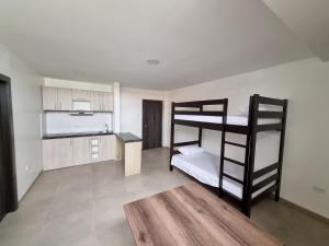 a room with two bunk beds and a kitchen at SUITES GARZOTA in Guayaquil