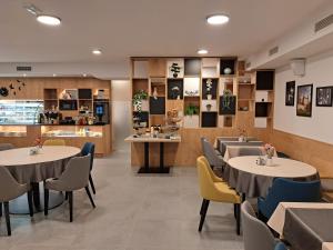 a restaurant with tables and chairs and a counter at Boutique Hotel Vila Loka in Škofja Loka