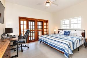 a bedroom with a bed and a desk with a computer at Hol Chan Reef Resort & Villas in San Pedro