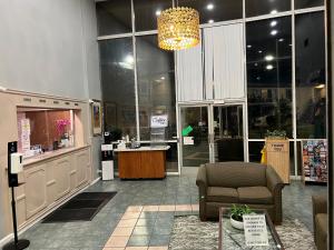 a store with a lobby with a chair and a counter at Hometown Inn North Hills in North Hills