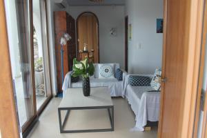 a living room with a couch and a table at A Crystal Clear House in Pyrgos, Heraklion Crete in Pírgos