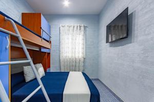a small bedroom with a bunk bed and a television at Appartamento Stella Marina 2 - MyHo Casa in San Benedetto del Tronto