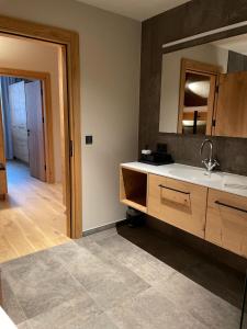 a bathroom with a sink and a mirror at Heimat 1495m Appartement TYP 2 light in Schröcken