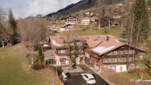 an aerial view of a house with a white van parked in front at Gasthof Tenne in Lenk
