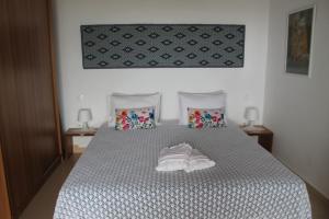 a bedroom with a bed with white shoes on it at A Crystal Clear House in Pyrgos, Heraklion Crete in Pírgos