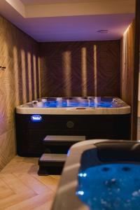 a jacuzzi tub with blue lights in a room at Parkowe Szczyrk in Szczyrk