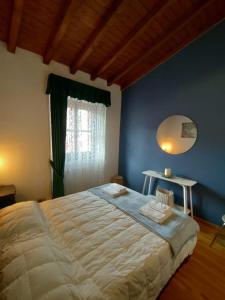 a bedroom with a large bed and a mirror at La Corte di Costantino-Downtown Como in Como