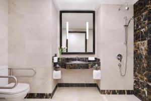 a bathroom with a sink and a toilet and a mirror at InterContinental Dar Al Hijra Madinah, an IHG Hotel in Medina