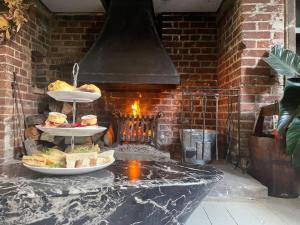 a brick oven with two plates of food on a table at Pass the Keys The Top Space in Hastings