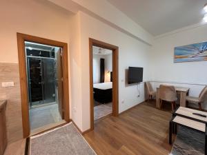 a living room with a room with a bed and a television at Old Town Vip Apartment in Novi Pazar