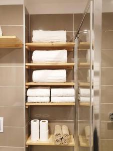 a towel rack with towels in a bathroom at La Stazione in Nogent-le-Rotrou