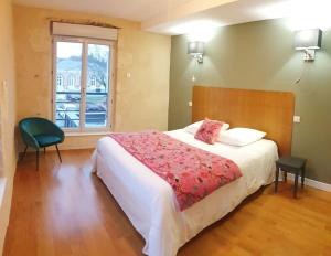 a bedroom with a large bed and a window at La Stazione in Nogent-le-Rotrou