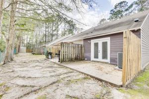 a house with a fence in front of it at Updated Tallahassee Townhome 3 Mi to Downtown! in Tallahassee