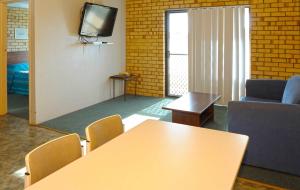 a room with a television and a table in it at Abrolhos Reef Lodge in Geraldton