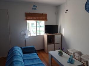 a living room with a couch and a table and a window at Albanta in Chipiona