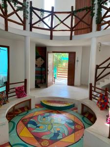 a room with a large colorful rug on the floor at Casa Redonda Hostal Inn 1 in Holbox Island