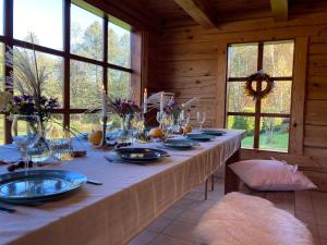 a long table in a wooden room with a table at FOREST RIVER RESORT in Vilnius
