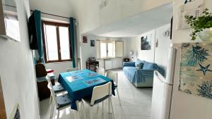 a kitchen and living room with a table and a couch at G&G- Amalfi coast - sea view - beach in Atrani