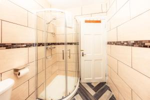 a bathroom with a shower and a glass door at Warm&Welcoming City Centre Apartments by Meadows 10 in Edinburgh