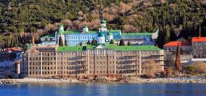 a large building on the shore of a body of water at Mouses-X in Nea Kallikrateia