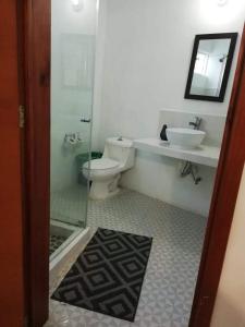 a bathroom with a toilet and a sink at Casa Redonda Hostal Inn 1 in Holbox Island