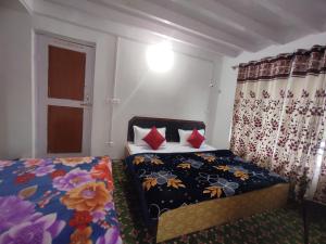 a bedroom with two beds and a window at Betab Valley Guest House Pahalgam in Pahalgām