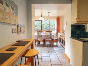 a kitchen and dining room with a table and chairs at Highgate in Llandudno