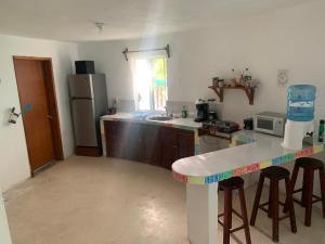 a kitchen with a counter top and a refrigerator at Casa Redonda Hostal Inn 1 in Holbox Island