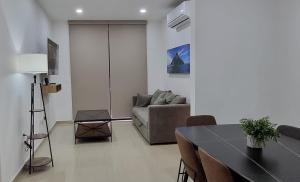 a living room with a couch and a table at Confortable Departamento in Mazatlán