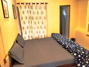a bed in a room with an american flag pattern at The Kashi Baba Homestay in Dharamshala