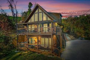 a large wooden house with a wrap around porch at Mountain Mist in Gatlinburg