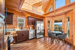 a kitchen with a table and chairs in a cabin at Mountain Mist in Gatlinburg