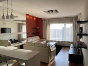 a living room with couches and a dining room at Апартаменты на Данилевского in Kharkiv