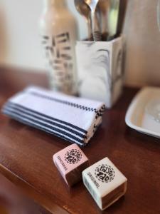 a wooden table with two pieces of soap on it at Salt 'n Paradise Luxury Surf and Beach Suites in Ubatuba
