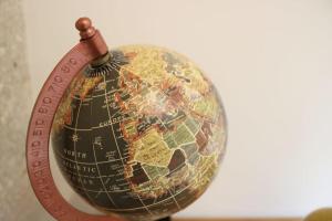 a close up of a globe with a magnifying glass at Cosy 2 chambres / Père-Lachaise in Paris