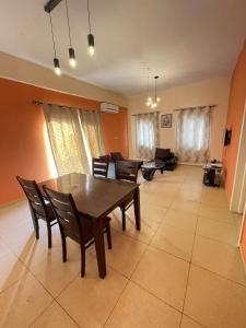 a living room with a wooden table and chairs at 2 bedrooms Apartment Devtraco Tema 25 in Tema