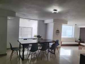 a dining room with a table and some chairs at Casa alberca cerca de todo. zona pastora. cochera in Monterrey