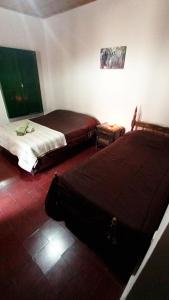 a bedroom with two beds in a room at Postales del Tiempo in Tilcara