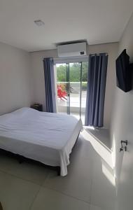 Кровать или кровати в номере Quartos Confortáveis - 5 min Aeroporto Internacional