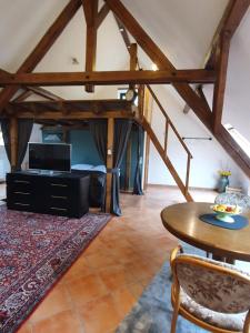 a living room with a table and a bed at Haus Husen in Xanten