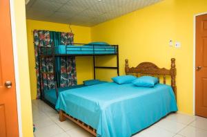 的住宿－3 Bedroom 5 Bathroom Beach House in Mayaro，一间卧室配有带蓝色床单的双层床